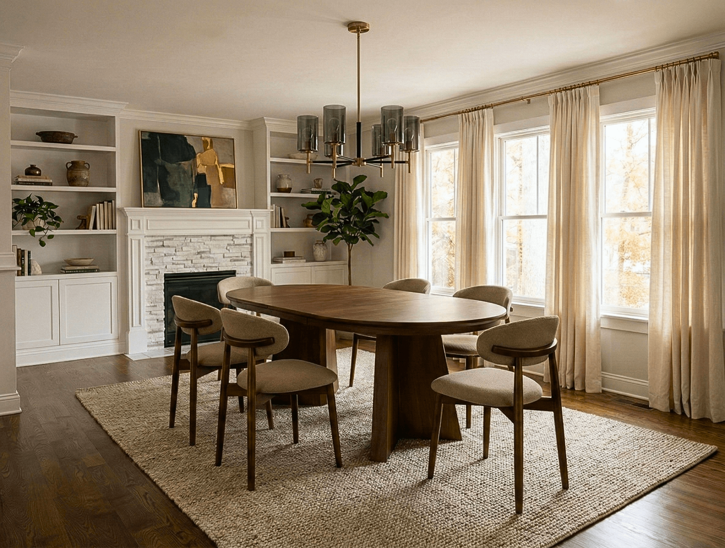 Elegant dining room featuring an oval wooden table, beige chairs, textured rug, and white fireplace.